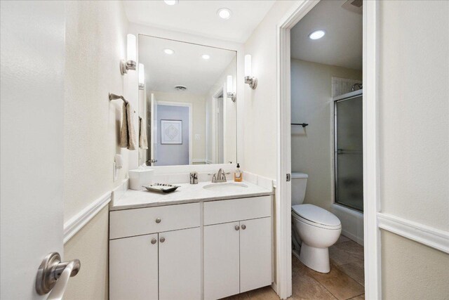 1801 Lavaca St Unit 9J, Austin, TX 78701 - bathroom with vanity, combined bath / shower with glass door, recessed lighting, and tile patterned floors