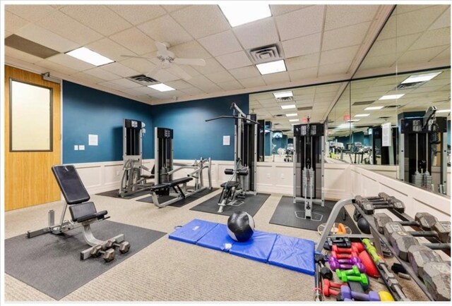 1801 Lavaca St Unit 9J, Austin, TX 78701 - exercise room featuring ceiling fan, a paneled ceiling, and a wainscoted wall