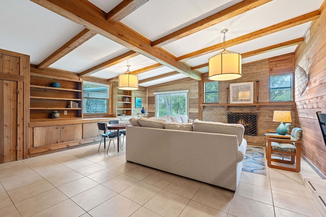 2609 Ellise Ave, Austin, TX 78757 - living room with wooden walls, a brick fireplace, light tile patterned floors, and built in features