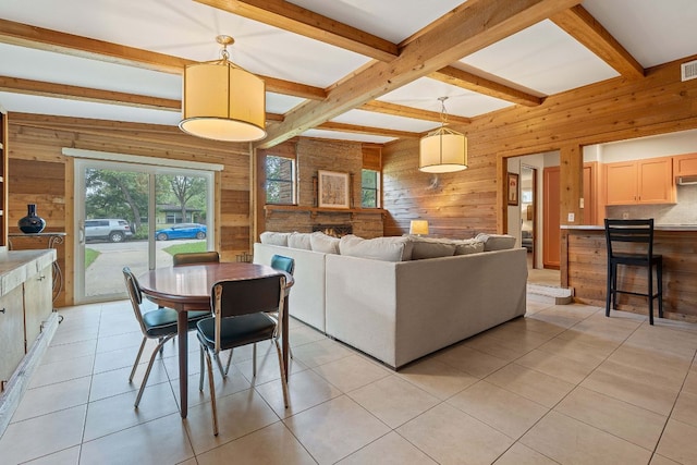 2609 Ellise Ave, Austin, TX 78757 - dining space featuring wooden walls, beamed ceiling, and light tile patterned floors
