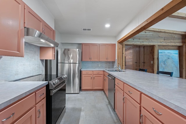 2609 Ellise Ave, Austin, TX 78757 - kitchen featuring under cabinet range hood, stainless steel appliances, tasteful backsplash, light countertops, and recessed lighting