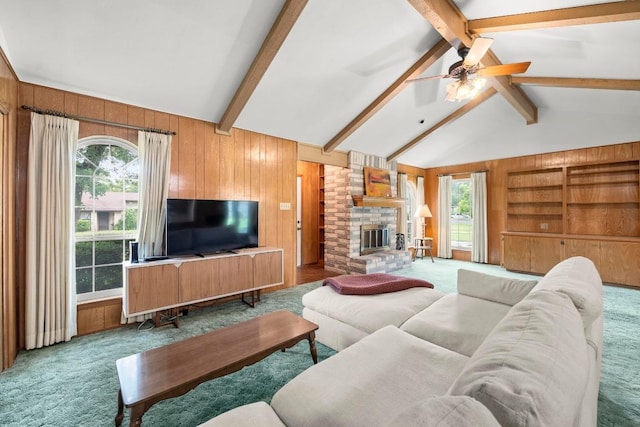1411 Shenandoah Dr, Cedar Park, TX 78613 - carpeted living area featuring wooden walls, ceiling fan, a fireplace, and built in shelves