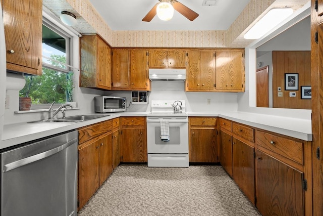 1411 Shenandoah Dr, Cedar Park, TX 78613 - kitchen with stainless steel appliances, under cabinet range hood, brown cabinetry, and ceiling fan