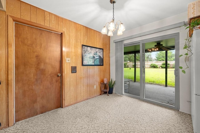 1411 Shenandoah Dr, Cedar Park, TX 78613 - doorway featuring carpet flooring, wood walls, and a chandelier