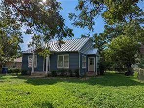 308 Taylor Rd, Elgin, TX 78621 - view of front of property with a standing seam roof, a front lawn, and a metal roof