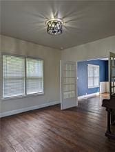 308 Taylor Rd, Elgin, TX 78621 - unfurnished living room with wood finished floors and a chandelier