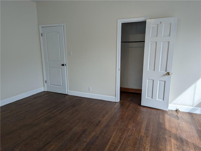 308 Taylor Rd, Elgin, TX 78621 - unfurnished bedroom with dark wood-style flooring and a walk in closet