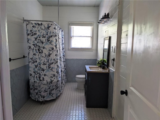 308 Taylor Rd, Elgin, TX 78621 - bathroom with tile walls, vanity, a shower with curtain, tile patterned floors, and wainscoting