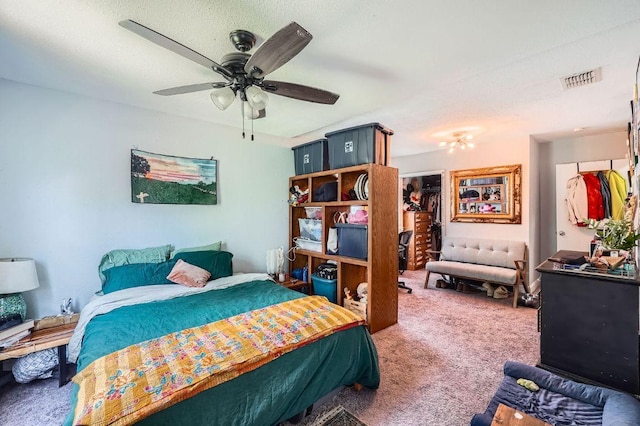 5605 Tura Ln, Austin, TX 78721 - bedroom featuring a walk in closet, carpet, and a ceiling fan