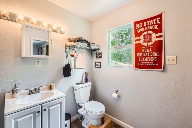 5605 Tura Ln, Austin, TX 78721 - half bath with vanity and wood finished floors