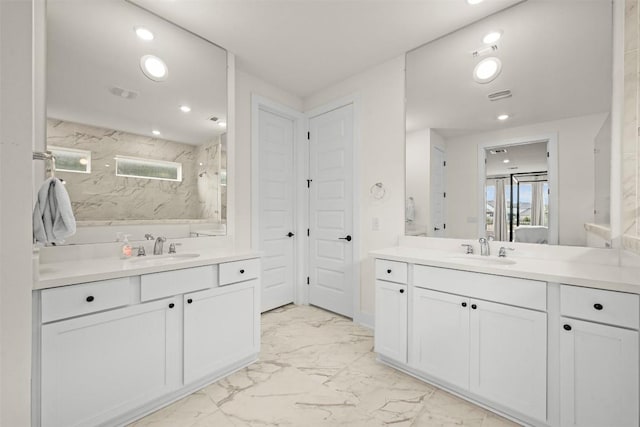 8405 Ambergill Ct, Austin, TX 78744 - bathroom with marble look tiles, two vanities, recessed lighting, and a marble finish shower