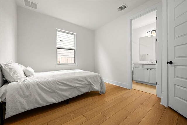 8405 Ambergill Ct, Austin, TX 78744 - bedroom featuring light wood finished floors and connected bathroom