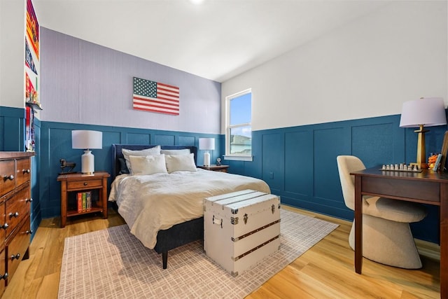8405 Ambergill Ct, Austin, TX 78744 - bedroom featuring a wainscoted wall, wood finished floors, and a decorative wall