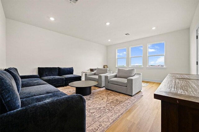 8405 Ambergill Ct, Austin, TX 78744 - living area with light wood-type flooring and recessed lighting