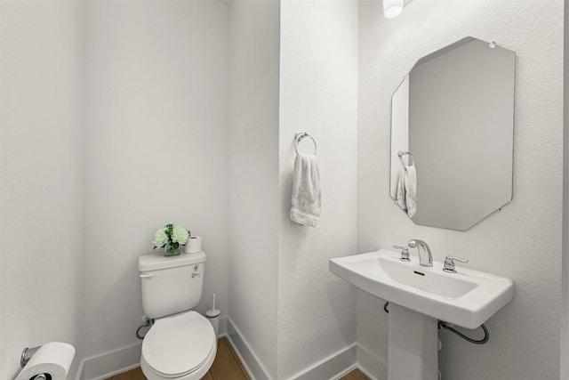 8405 Ambergill Ct, Austin, TX 78744 - half bathroom featuring toilet and wood finished floors