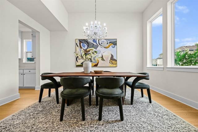 8405 Ambergill Ct, Austin, TX 78744 - dining room with healthy amount of natural light, light wood-style floors, and a chandelier
