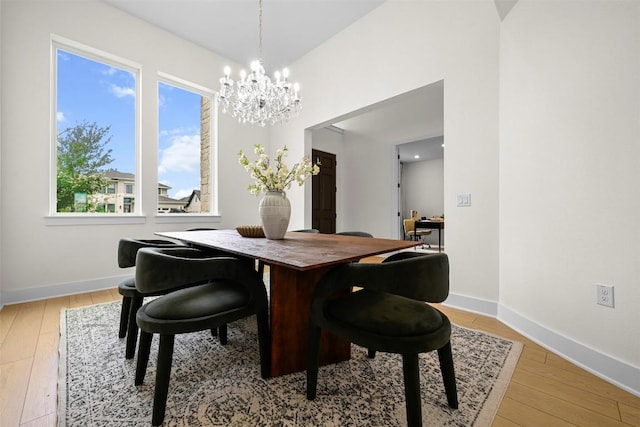 8405 Ambergill Ct, Austin, TX 78744 - dining area with a chandelier and wood-type flooring