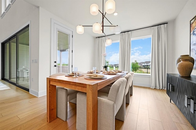 8405 Ambergill Ct, Austin, TX 78744 - dining space with light wood-type flooring, a chandelier, and recessed lighting
