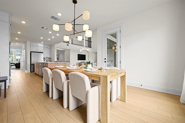8405 Ambergill Ct, Austin, TX 78744 - dining room featuring light wood-type flooring, a chandelier, and recessed lighting