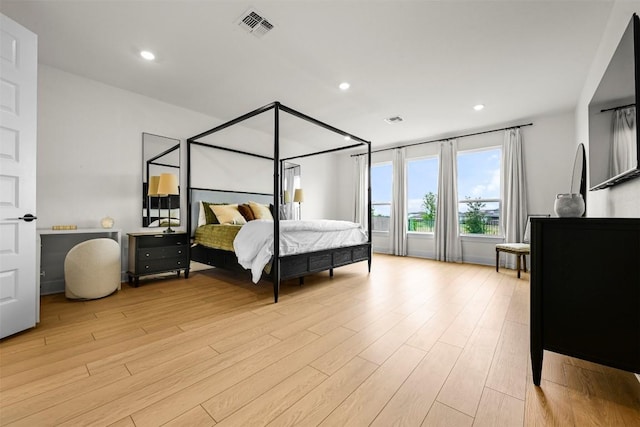 8405 Ambergill Ct, Austin, TX 78744 - bedroom with light wood-style floors and recessed lighting
