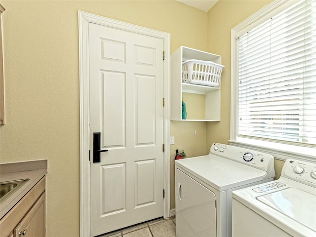8212 Barton Club Dr Unit 9-10, Austin, TX 78735 - washroom featuring washing machine and clothes dryer, cabinet space, and light tile patterned floors
