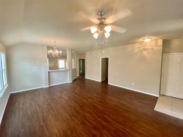 358 Spring, Kyle, TX 78640 - unfurnished living room featuring dark wood-type flooring, a chandelier, ceiling fan, and vaulted ceiling