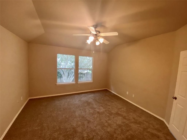 358 Spring, Kyle, TX 78640 - unfurnished room featuring a ceiling fan, dark colored carpet, and vaulted ceiling