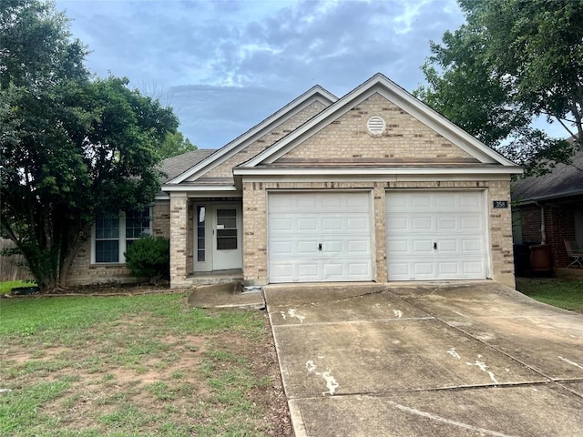 358 Spring, Kyle, TX 78640 - single story home with brick siding, concrete driveway, and an attached garage