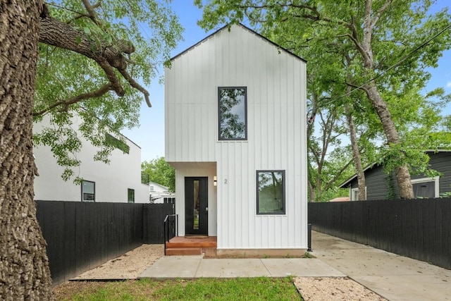 4428 Jinx Ave Unit 2, Austin, TX 78745 - rear view of house with a fenced backyard and board and batten siding