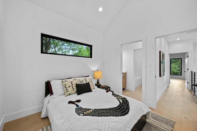 4428 Jinx Ave Unit 2, Austin, TX 78745 - bedroom with light wood-style flooring, recessed lighting, ensuite bath, and high vaulted ceiling