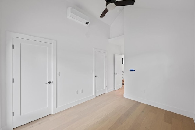 4428 Jinx Ave Unit 2, Austin, TX 78745 - unfurnished bedroom featuring high vaulted ceiling, a wall mounted air conditioner, light wood-style flooring, and a ceiling fan