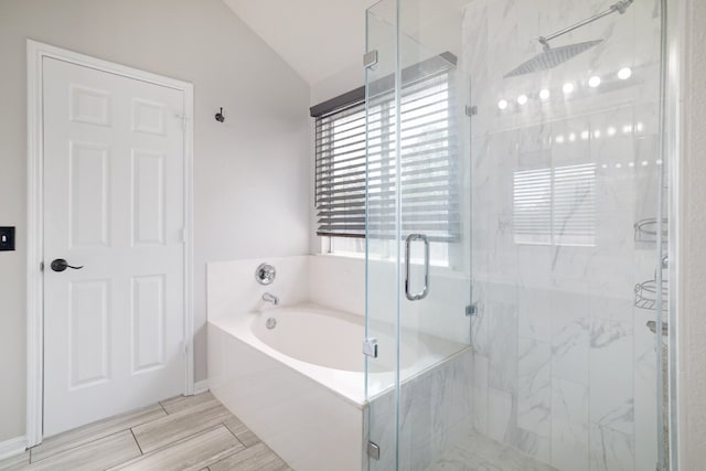 203 Endeavour, Kyle, TX 78640 - bathroom featuring lofted ceiling, a garden tub, and a marble finish shower