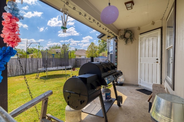 203 Endeavour, Kyle, TX 78640 - fenced backyard with a trampoline and a patio area
