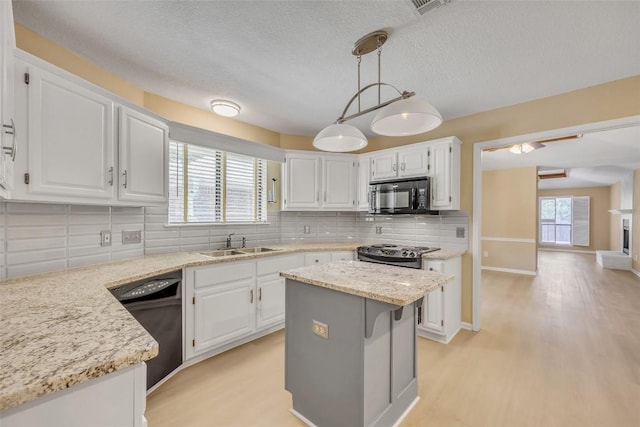 10007 Brantley Bnd, Austin, TX 78748 - kitchen featuring black appliances, white cabinetry, light wood-style floors, and a textured ceiling