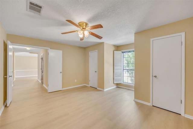 10007 Brantley Bnd, Austin, TX 78748 - unfurnished bedroom with light wood-style floors, a textured ceiling, and ceiling fan