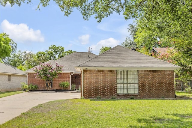 10007 Brantley Bnd, Austin, TX 78748 - view of front of property with a front lawn, brick siding, a shingled roof, and concrete driveway