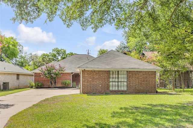10007 Brantley Bnd, Austin, TX 78748 - view of front of house featuring a front yard, brick siding, and concrete driveway
