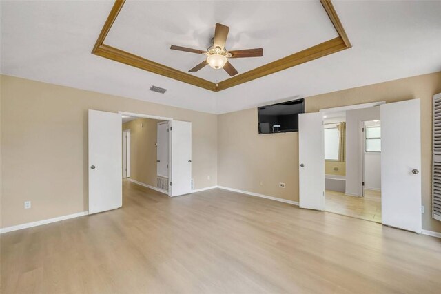 10007 Brantley Bnd, Austin, TX 78748 - unfurnished room with a tray ceiling, ceiling fan, light wood-type flooring, and crown molding