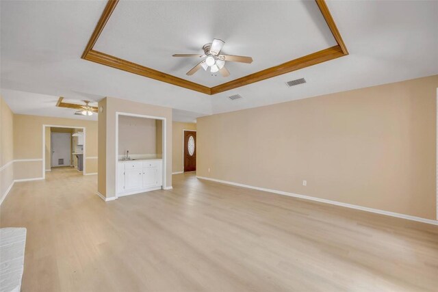 10007 Brantley Bnd, Austin, TX 78748 - unfurnished living room with a raised ceiling, a ceiling fan, and light wood finished floors