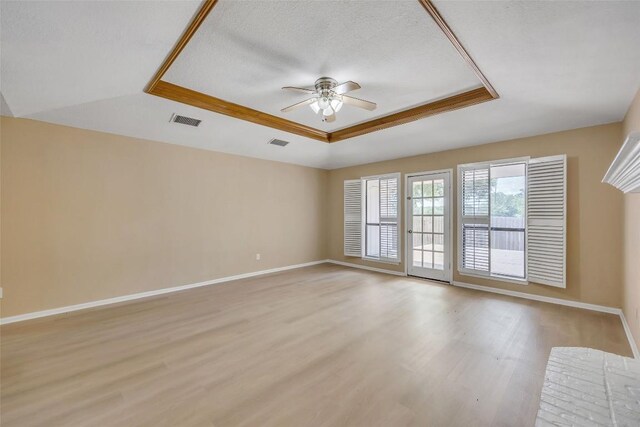 10007 Brantley Bnd, Austin, TX 78748 - spare room with a raised ceiling, a ceiling fan, and light wood finished floors