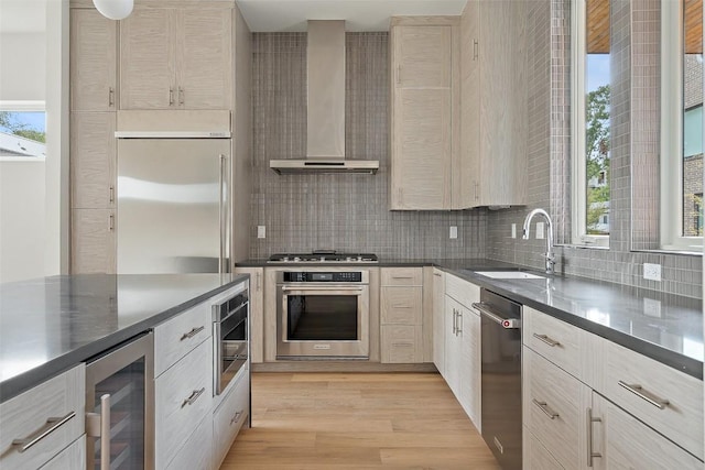 900 S 2nd St Unit 18, Austin, TX 78704 - kitchen with appliances with stainless steel finishes, wall chimney range hood, wine cooler, tasteful backsplash, and healthy amount of natural light