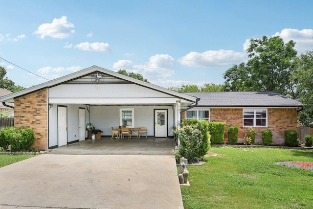 709 Harvey Ave, Burnet, TX 78611 - ranch-style house with driveway, brick siding, a carport, and a shingled roof