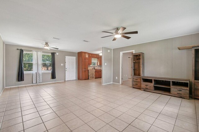 709 Harvey Ave, Burnet, TX 78611 - unfurnished living room with ceiling fan and light tile patterned flooring
