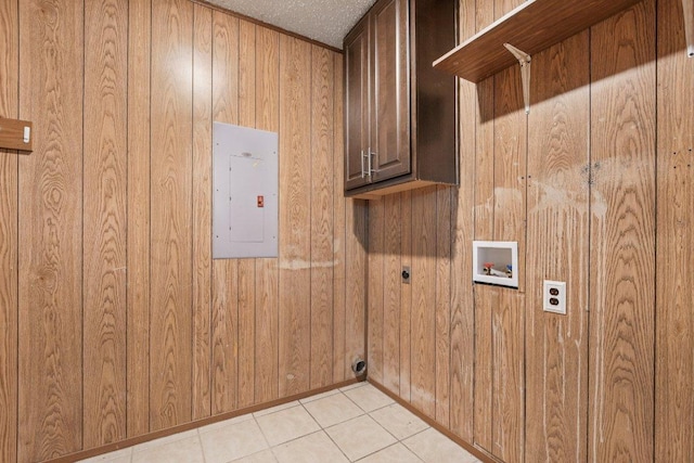 709 Harvey Ave, Burnet, TX 78611 - laundry room with cabinet space, electric panel, washer hookup, wooden walls, and hookup for an electric dryer
