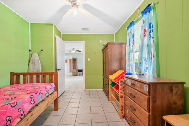 709 Harvey Ave, Burnet, TX 78611 - bedroom with light tile patterned floors, ceiling fan, and ornamental molding