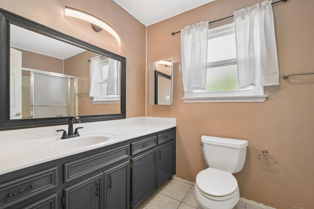 709 Harvey Ave, Burnet, TX 78611 - bathroom with vanity, tile patterned floors, and a shower with shower door