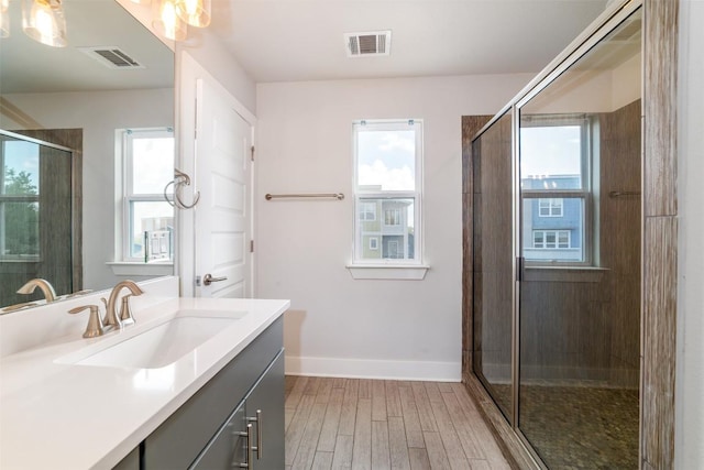 1904 Cleese Dr Unit 172, Austin, TX 78741 - bathroom featuring vanity, wood finished floors, and a stall shower