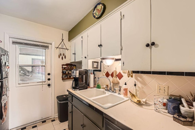 3309 Whitepine Dr, Austin, TX 78757 - kitchen with light countertops, white cabinets, and decorative backsplash
