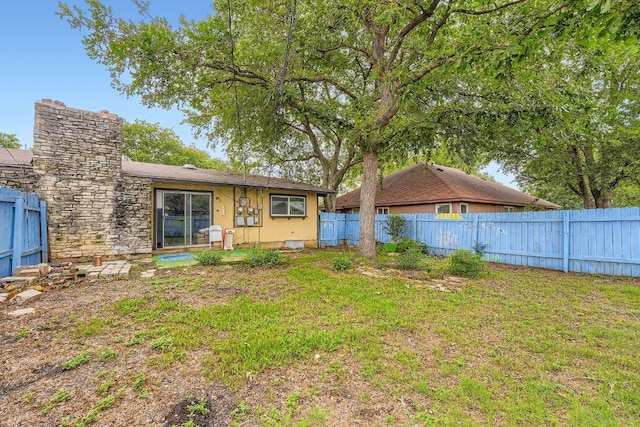3309 Whitepine Dr, Austin, TX 78757 - back of property featuring a fenced backyard and a chimney