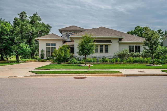 1404 Scenic Oaks Dr, Georgetown, TX 78628 - prairie-style home with stone siding, stucco siding, and a front lawn